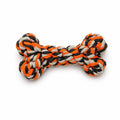 Dog toy in the shape of a bone with orange, black, and white braided rope on a white background