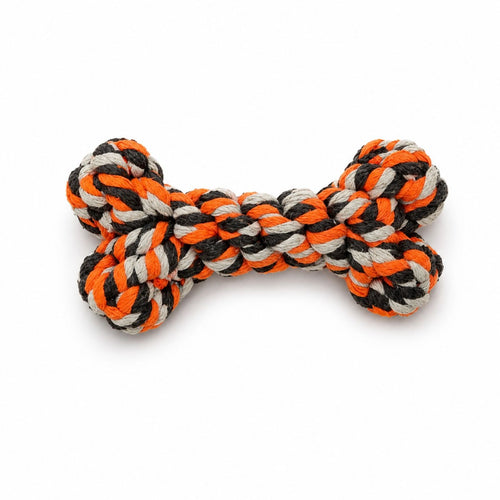 Dog toy in the shape of a bone with orange, black, and white braided rope on a white background