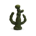 Green cactus-shaped candle on a white background