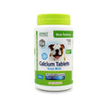 Bottle of calcium tablets for dogs with a green lid on a white background